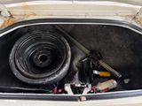 a car trunk with tools in it and a tire