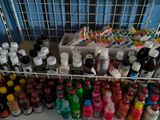 many bottles and cans of paint on a shelf