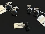 three pairs of eyeglasses are sitting on a black surface