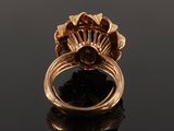 a close up of a gold ring on a black surface