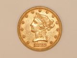 a close up of a gold coin with a woman ' s head on it