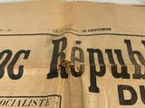 an old newspaper with a black and white image on it