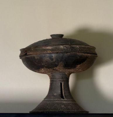 a small black object on a shelf in a room