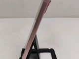 a close up of a cell phone on a stand on a table