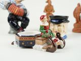a figurine of a man riding a horse and a dog on a sleigh