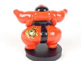 a red and black statue of a sumo with a black belt