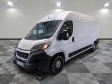the white van is parked on a checkered tile floor
