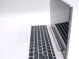 a white laptop with a black keyboard on a white surface