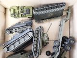 a box full of toy army vehicles and other items