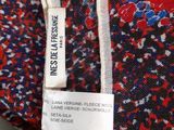 a close up of a red, white, and blue floral print shirt