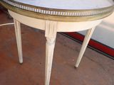 a white table with a gold rim on it