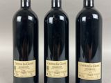 three bottles of wine sitting next to each other on a table