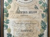 an old certificate with a bird on top of it in a frame