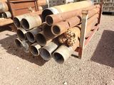 a pile of pipes sitting on the ground next to a truck