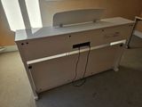 a white piano sitting in a room with a window in the background