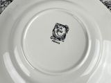 three plates with black and white designs are stacked on top of each other
