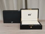 a black box with a watch inside of it on a table