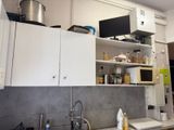 a kitchen with a sink, microwave, and cabinets in it