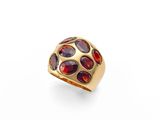 a gold ring with garnets and garnets on a white background