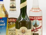 several bottles of alcohol are lined up on a white surface