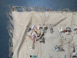 a piece of cloth with a picture of people on it