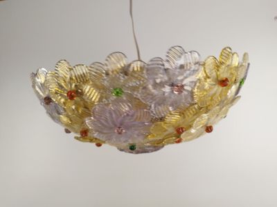 a glass bowl hanging from the ceiling in a room