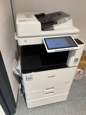 a photo of a multi - function printer with a tablet on top of it