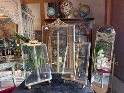 three glass vases sitting on a table in a room