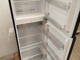 an open refrigerator that is sitting in a room