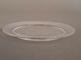 a clear glass plate with a silver rim on a table