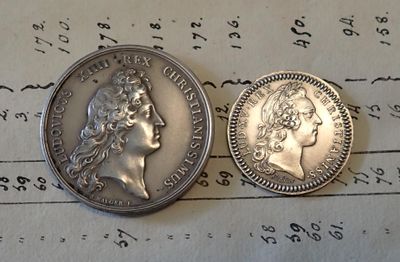 deux pièces d'argent posées sur un morceau de papier