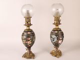 pair of antique lamps with floral designs on them on a white background