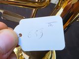 a person holding a tag with a picture of a musical instrument