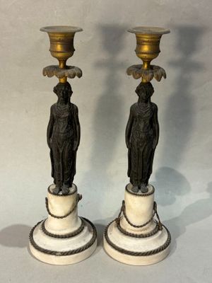 two candles that are sitting on top of each other