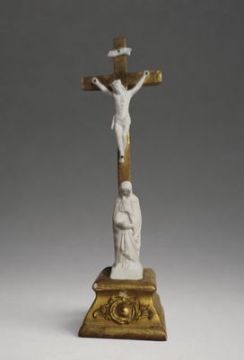 statue of a crucifix with a man on a cross on a pedestal