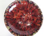a red and yellow bowl on a white table