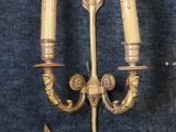 two wall sconces that are attached to the wall