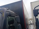 two trucks that are parked next to each other