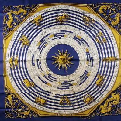 a blue and yellow scarf with a sun on it