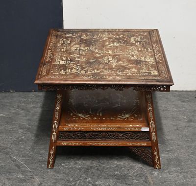 an old wooden table with a decorative design on top of it
