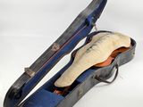 a guitar case with a guitar in it on a white background