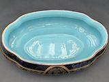a blue bowl with a gold rim on a table