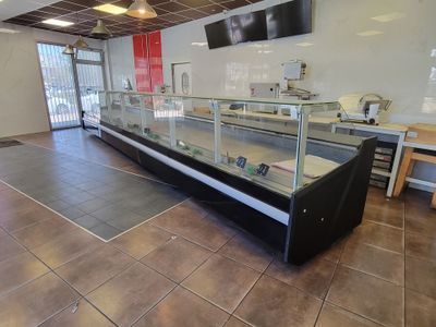 a glass display case in the middle of a restaurant