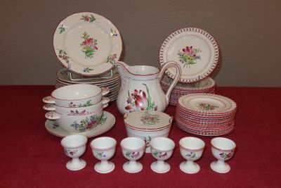 a table with a bunch of dishes and cups on it