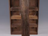 an old wooden bookcase with two shelves and a door