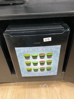 a picture of a fridge with a picture of cupcakes on it