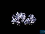 a close up of a pair of diamonds on a black background