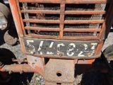 a rusted old tractor with a number plate on it