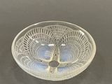 a glass bowl with a design on it on a table