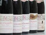 several bottles of wine are lined up in a row on a table